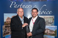 Todd Anglin, National Sales Manager, Zurn Pex, Inc. (right) accepts award from David M. Weekley, Chairman of David Weekley Homes