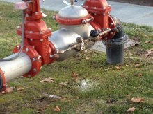 Freeze prevention device on manufacturer's property (Zurn Wilkins). Ice on the grass below illustrates that the device is working properly in freeze conditions.